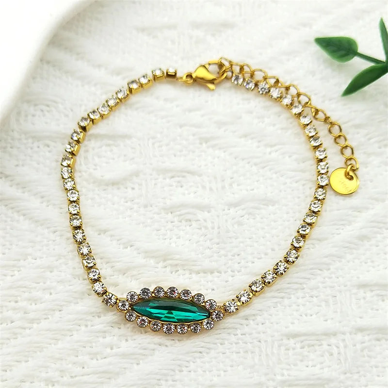 Goldfarbenes Edelstahl Armband mit blau grünem Auge und Strass für Damen