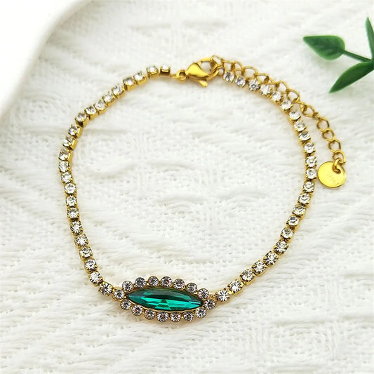 Goldfarbenes Edelstahl Armband mit blau grünem Auge und Strass für Damen