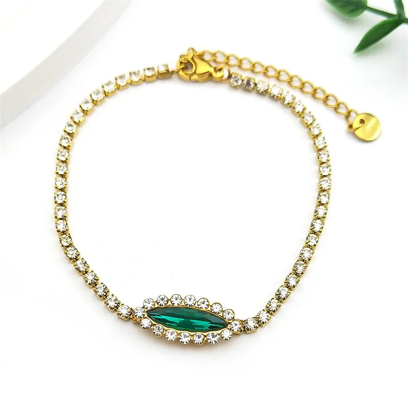 Goldfarbenes Edelstahl Armband mit blau grünem Auge und Strass für Damen